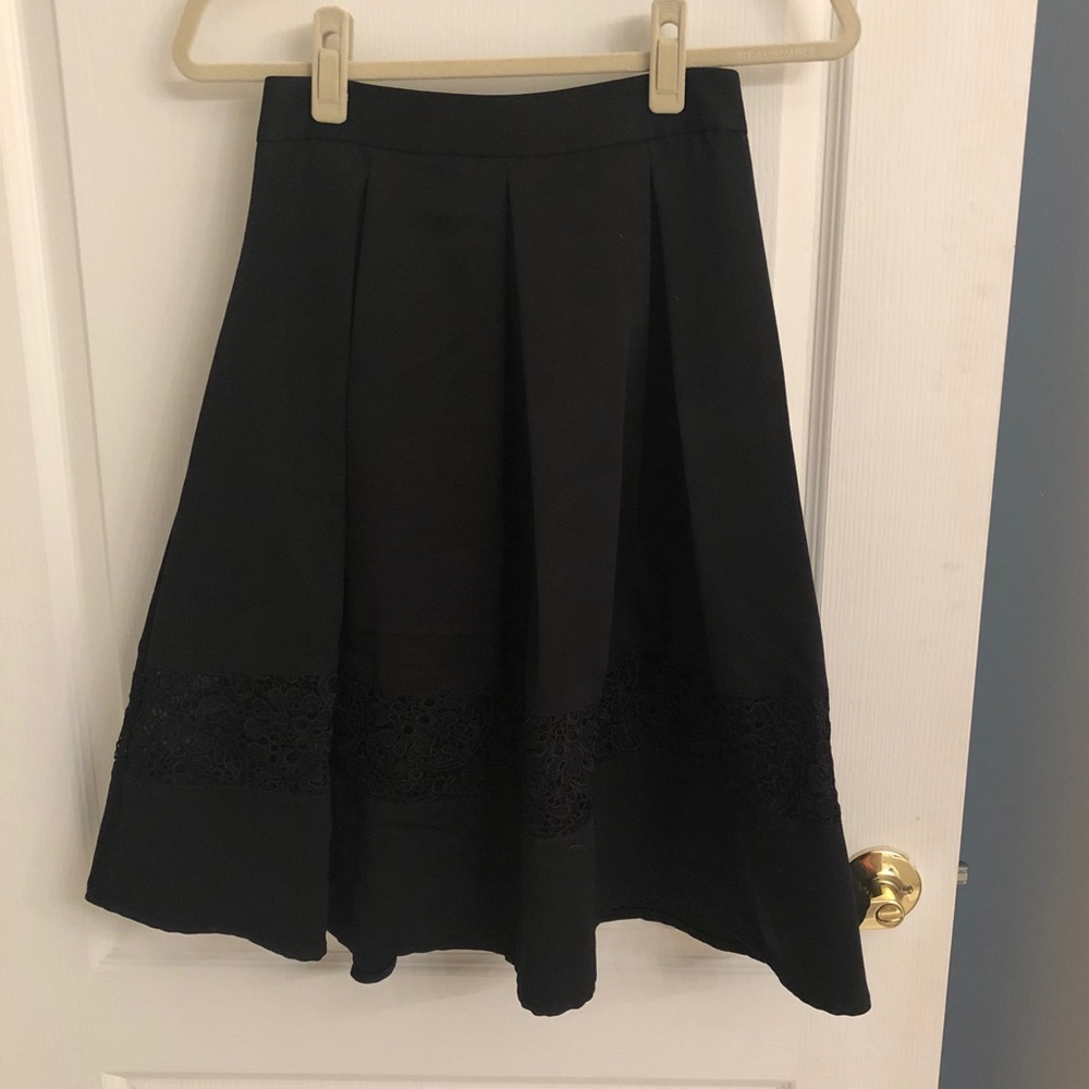 Black pleated knee length skirt